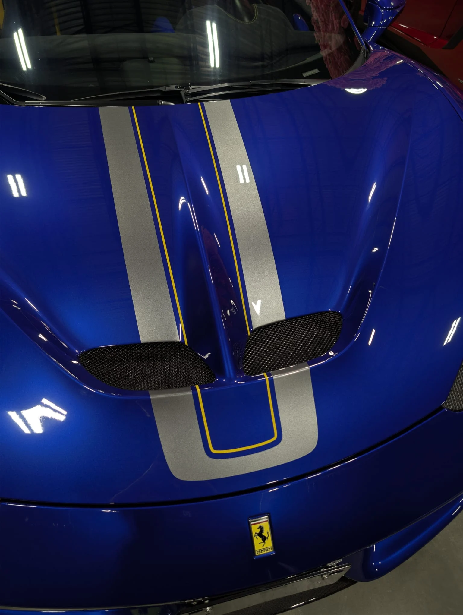 Blue Ferrari with silver racing stripes photographed in the It's Unique studio